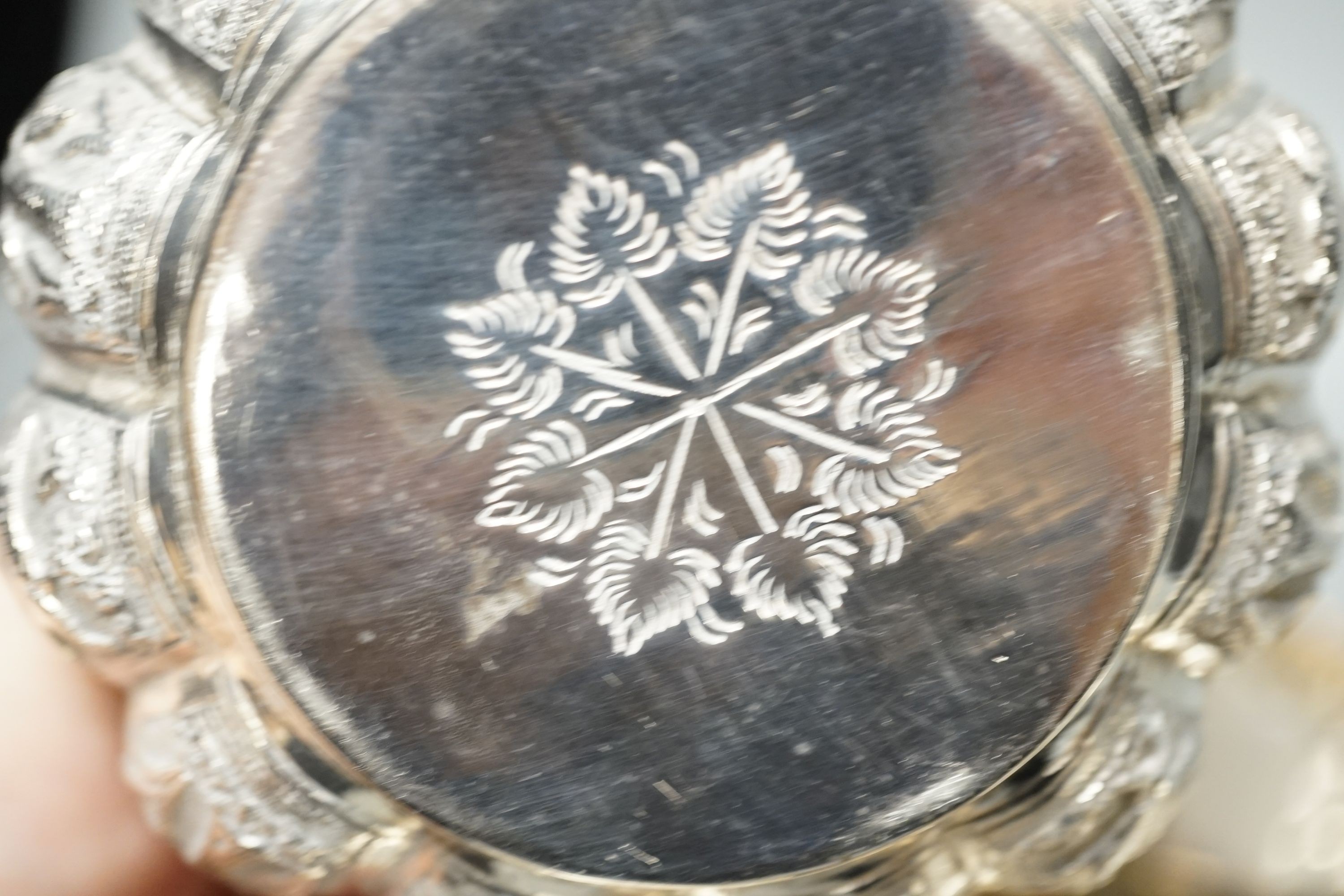 Four small Rangoon white metal bowls together with a simile basket and six small white metal bowls with heraldic motifs, gross 24.5oz.